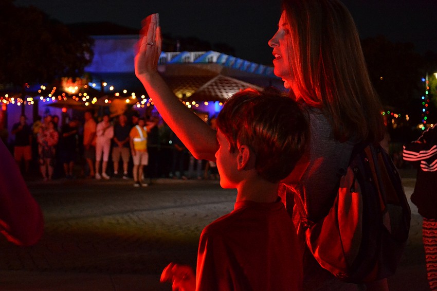 Owen and Angie Carr' s faces glow with light from the fire engine making its way down Ocean Boulevard during the Light Up The Village parade Saturday, Nov. 26.