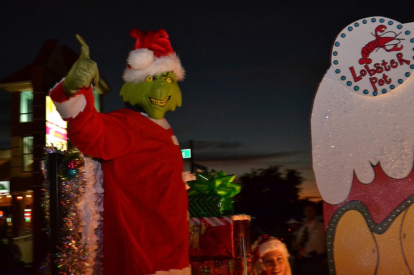The Grinch himself rides along on the Lobster Pot restaurant float.