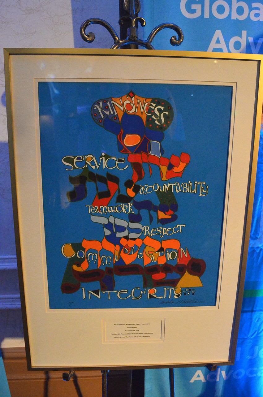 Walsh’s award was a piece of art mixing Hebrew and English words — the seven that AJC members think best describe her.