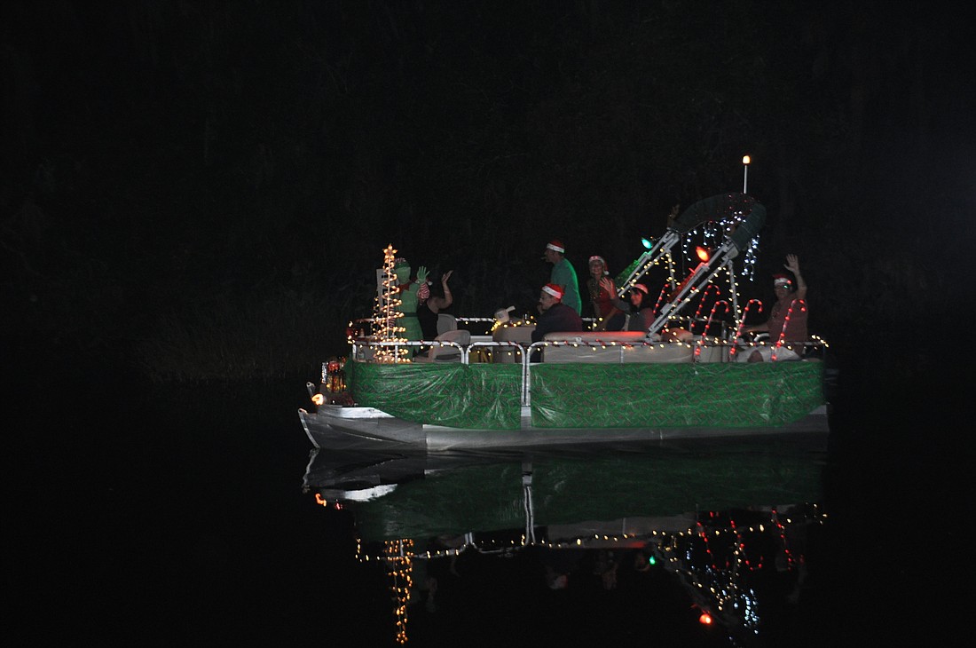 A decorated boat makes its way to Linger Lodge during the 2013 parade. File photo.