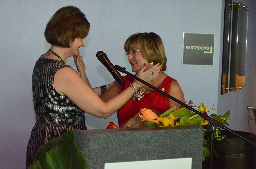 Neuro Challenge Foundation Executive Director Robyn Faucy surprises Judith Bell, prior executive director, with flowers and a special thank you.