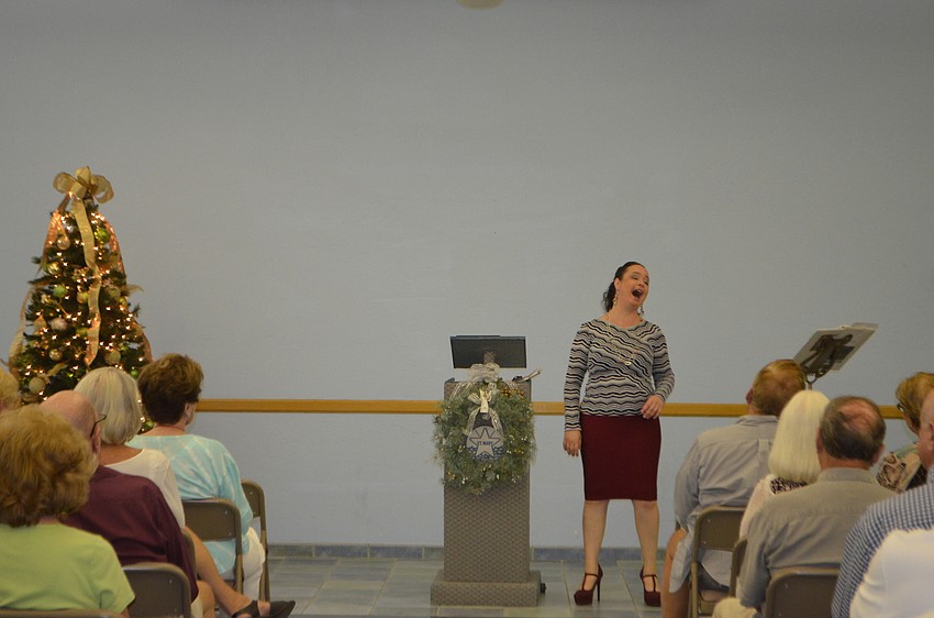 Opera singer and soloist with the St. Petersburg and Sarasota operas performed various Christmas songs during the St. Mary, Star of the Sea, Catholic Church holiday party.