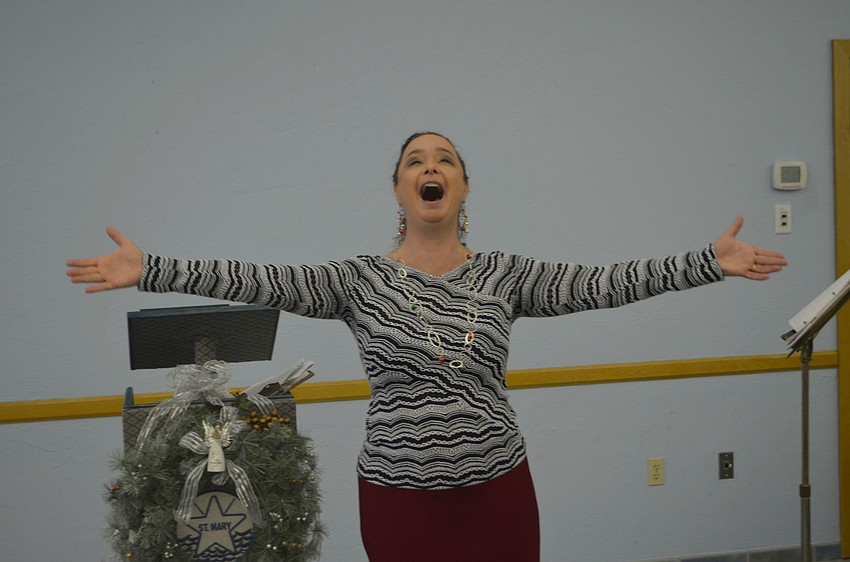 Opera singer and soloist with the St. Petersburg and Sarasota operas performed various Christmas songs during the St. Mary, Star of the Sea, Catholic Church holiday party.