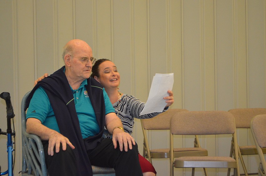 Monsignor Gerard Finegan sings along with Michelle Giglio.