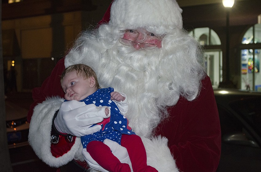 Santa Claus holds 2-month-old Zyana Roell.