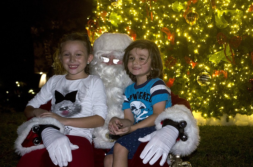 Nicole and Paul Schutze pose with Santa Claus.