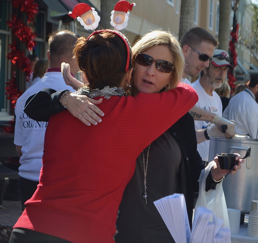Violeta Huesman of Kaiser University, gives Lakewood Ranch' s Pam White a hug during Empty Bowls.