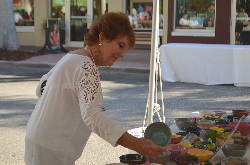 Pam Swart, a visitor from South Africa, looks at one of the 500 bowls up for grabs.
