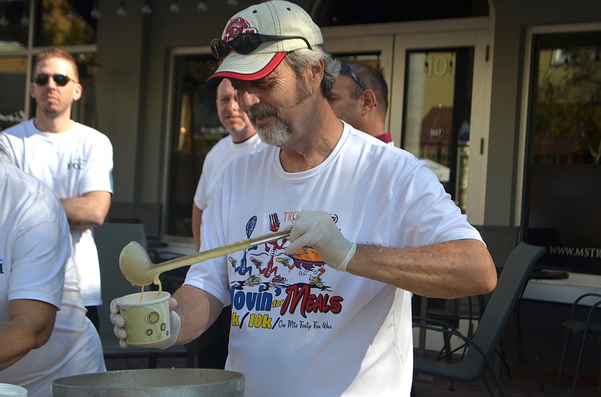 Joe Angers, a volunteer with The Food Bank of Manatee, pours beer cheese soup.