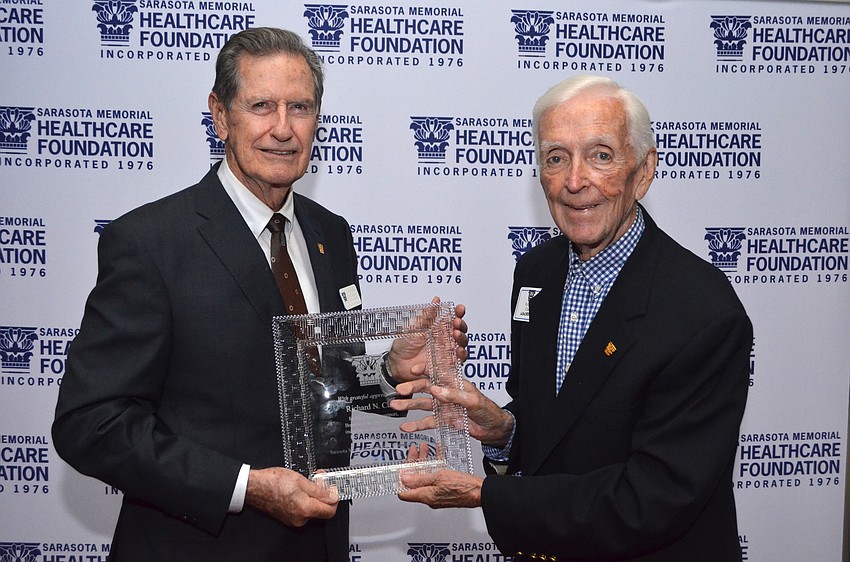Chairman of the Sarasota Memorial Healthcare Foundation Board of Trustees Jim Syprett with Dick Clark, outgoing foundation trustee