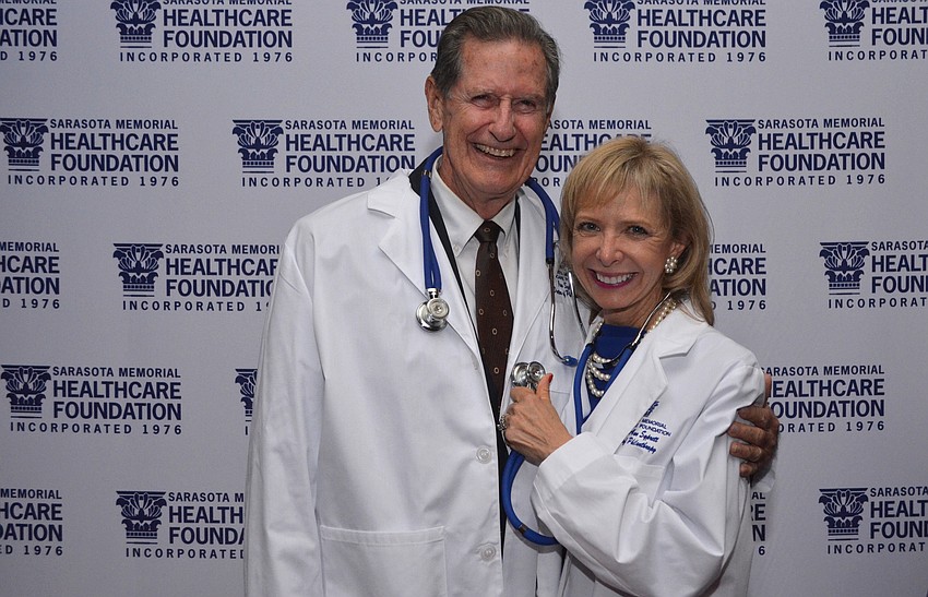 Chairman of the Sarasota Memorial Healthcare Foundation Board of Trustees Jim Syprett with his wife, Charlie Ann Syprett, after receiving their Doctors of Philanthropy lab coats