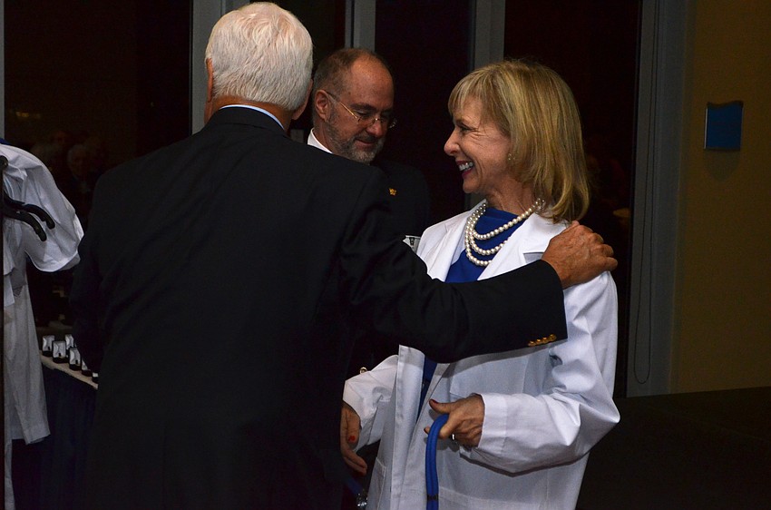 Charlie Ann Syprett smiles after receiving her Doctors of Philanthropy lab coat.