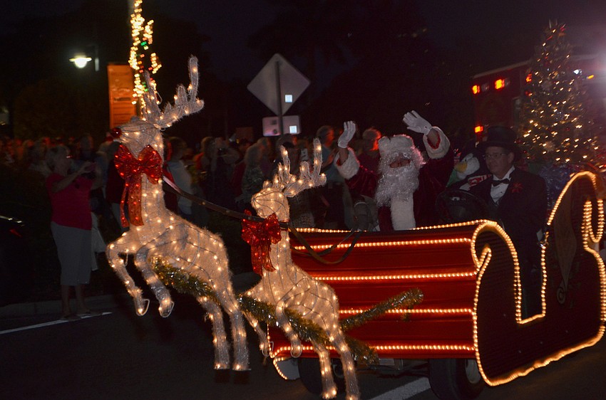 Santa Claus waves to the crowd as he arrives at the 38th Annual Holiday Night on St. Armands.
