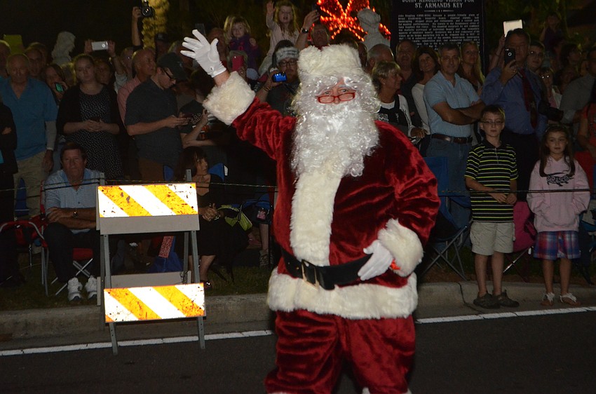 Santa Claus waves as the crowd cheers him on at 38th Annual Holiday Night on St. Armands.