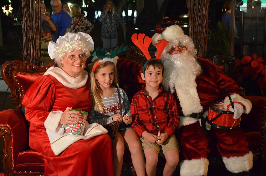 Brooke, 6, and Blake Gruhl, 4, smile with Mrs. Claus and Santa Claus.
