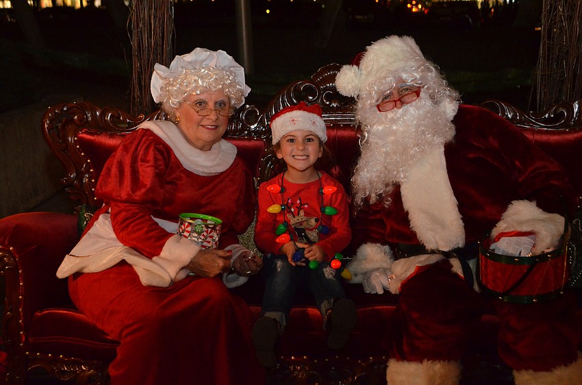Adrianna Minore, 5, with Mrs. Claus and Santa Claus