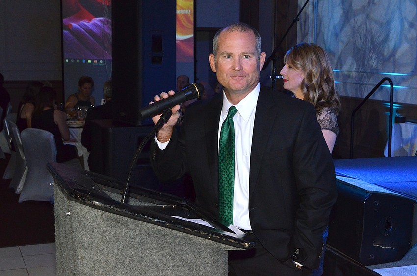 Larry Lawman, chair of the Florida Center board of directors, smiles as he waits for the crowd to quiet down she he can begin the program.