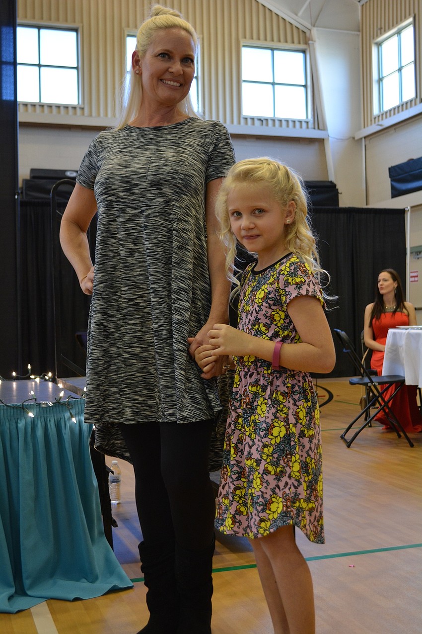 Braden River Elementary' s Caitlin Motherway, 6, is shy but gains confidence as she models alongside her mom, Jill Motherway.
