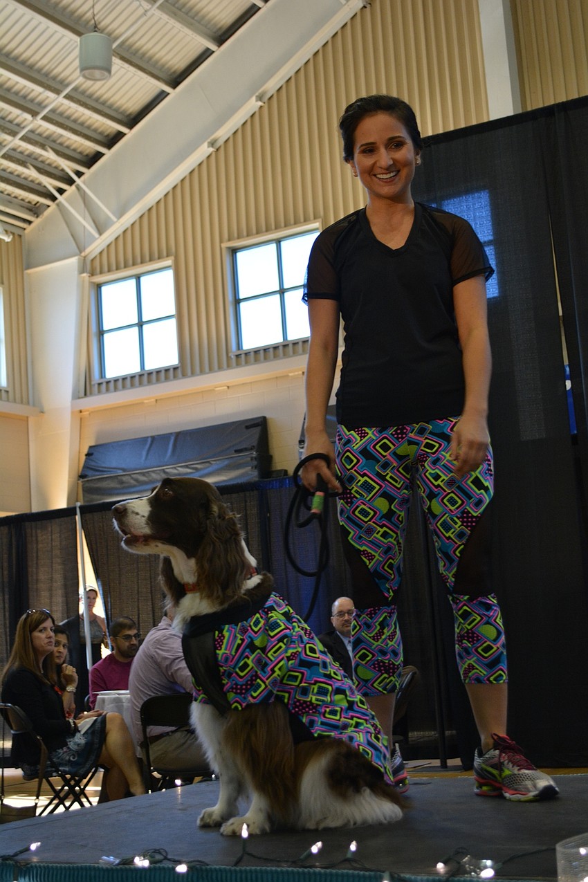 Lakewood Ranch YMCA group fitness instructor Lindsay Freeman, of Central Park, walks the runway with her dog, Olive, to show designs by Purabell House of Fashion.
