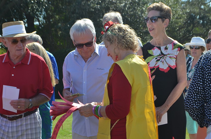 Christine Olsen sells tickets for the  Edith Barr Dunn Memorial 50/50 Raffle.
