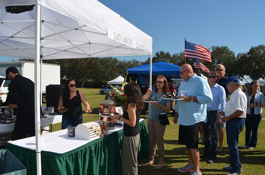 Attendees wait in line at The Lazy Lobster booth.