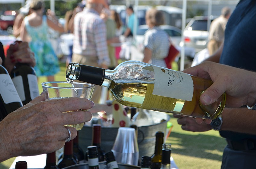 Paul Kauffman of Republic National pours wine for attendees.