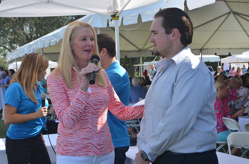 Susan Phillips introduces Nick Karpathy, the 2015 Edith Barr Dunn scholarship recipient, to the crowd.