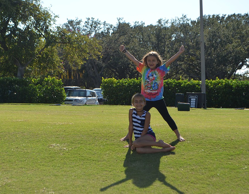Stella, 8, and Alexandra Misantone, 6, play on the islandside driving range of the Longboat Key Club during the lawn party.