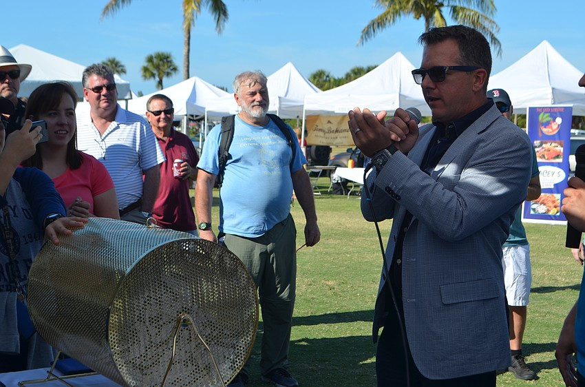 Chuck Whittall, president of Unicorp National Developments Inc., and the platinum sponsor for the lawn party announces the grand prize raffle winner.