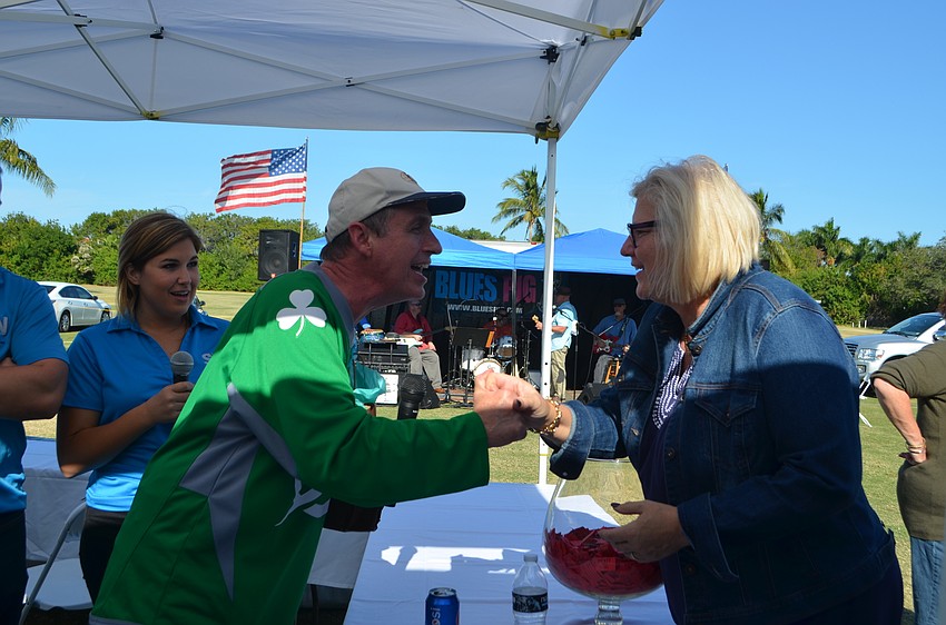 Michael Garey congratulates Ashley Reim on winning the Longboat Key Getaway raffle prize.