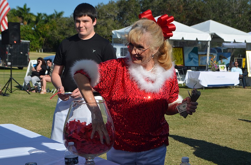Lynn Larson picks the winning ticket in the “Edith Barr Dunn Memorial 50/50 Raffle.”