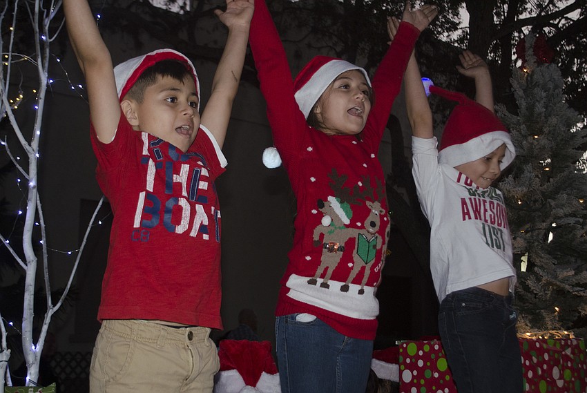 Jaden Araujo, natalie Araujo and Diego Jaimes practice their dance moves while waiting for the parade to begin.