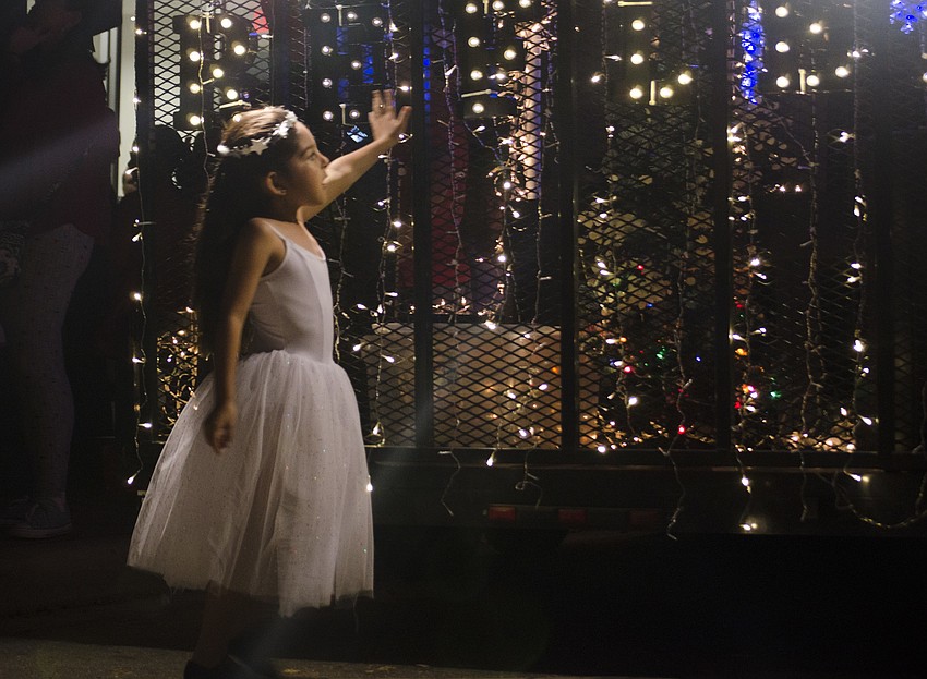Barbara Sanchez investigates the lights on the back of the Reflec Dance Studio float.