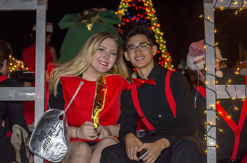 Zoe Ganley and Victor Garcia wait for the parade to start on the back of the Sarasota High School theater group’s float.