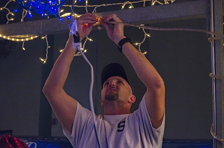 Andy Berster makes some final adjustments on Sarasota Crew’s float.