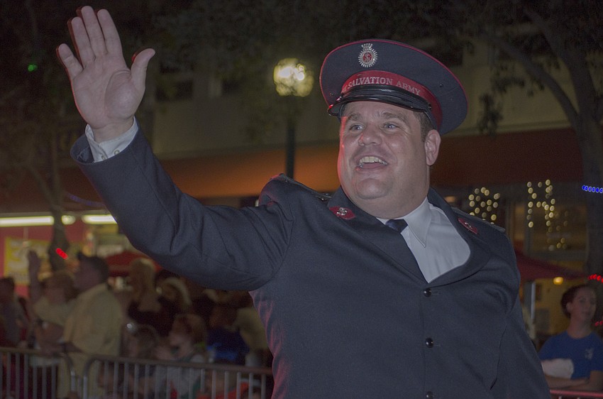 Salvation Army Major Ethan Frizzell marches in the Holiday Parade Saturday evening in downtown Sarasota.