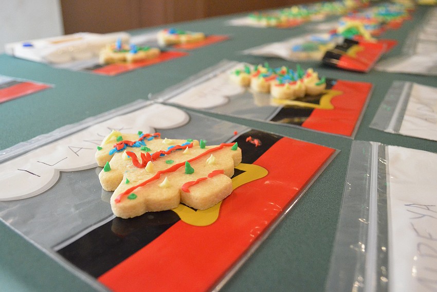 Cookies lay in a line before being picked up by their decorators at the end of the event.