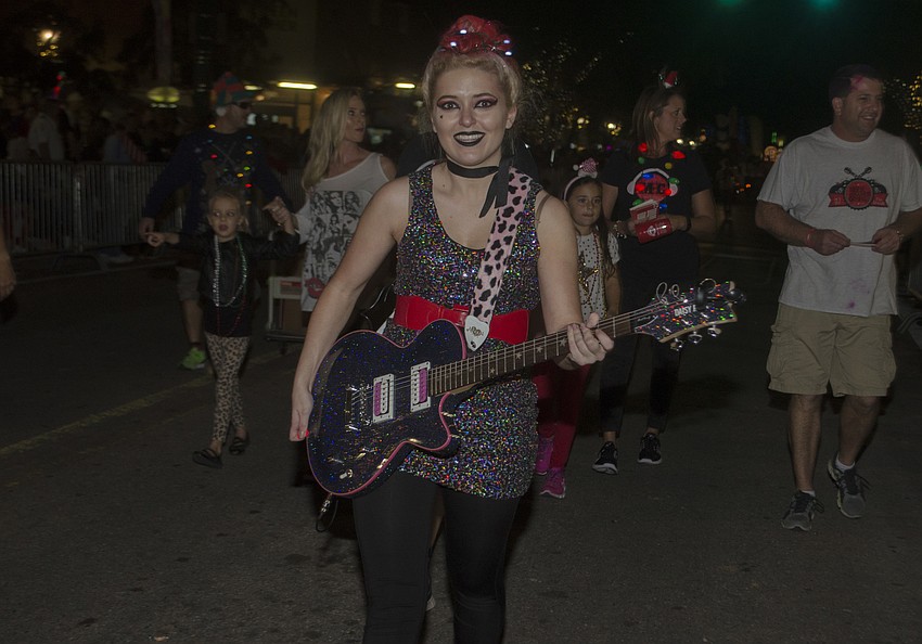 Music Compound instructor Savannah Brady marches in the Downtown Holiday Parade.