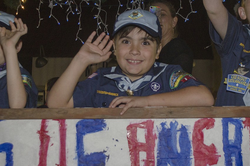 Bruno Cruz waves while riding on the Boy Scout’s float.