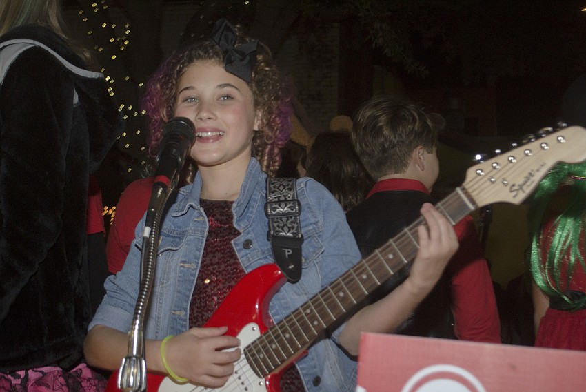 Lily Mae Stewart sings on the Music Compound Float.