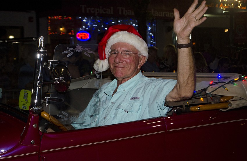 Alan Guttrige drives an antique car in the Downtown Holiday Parade.