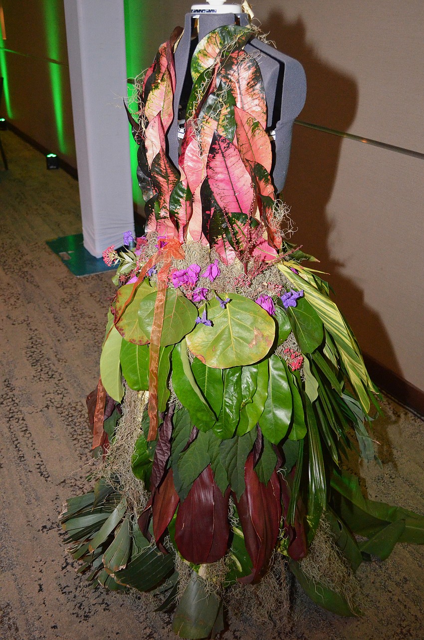 A handmade “enchanted garden”-themed gown designed by Anne Chauvet added to the botanical motif.