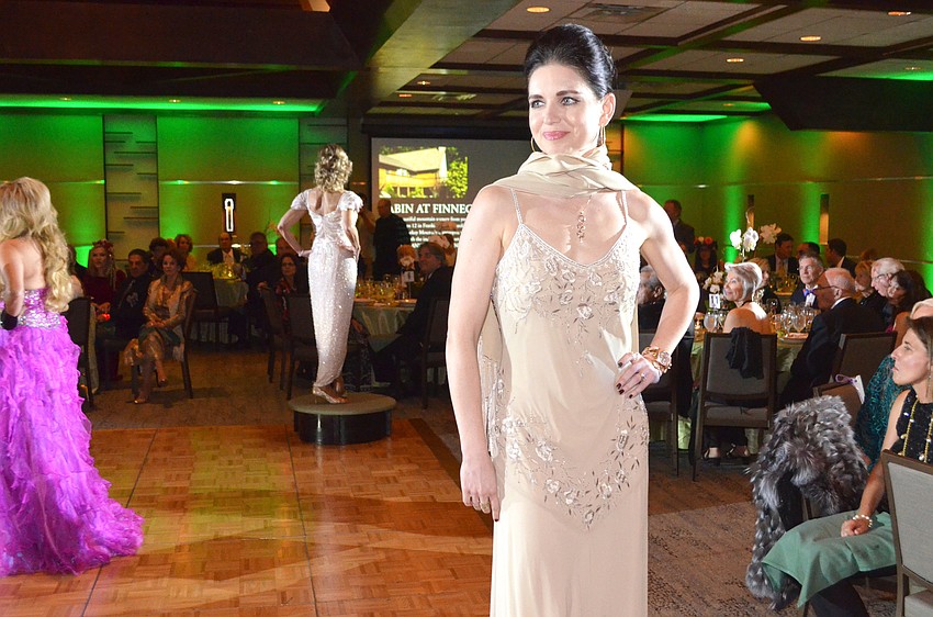 Olga Giminez models a gown from Designing Women Boutique.
