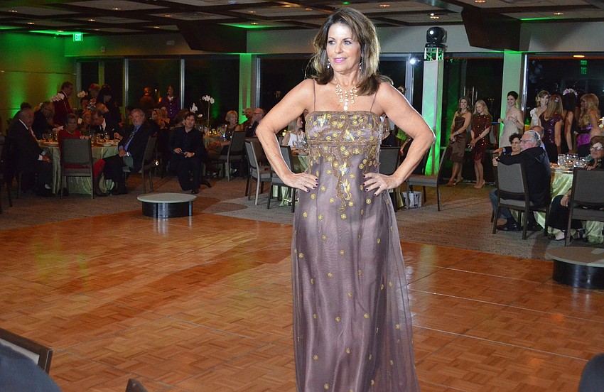 Sandy Moore models a gown from Designing Women Boutique.