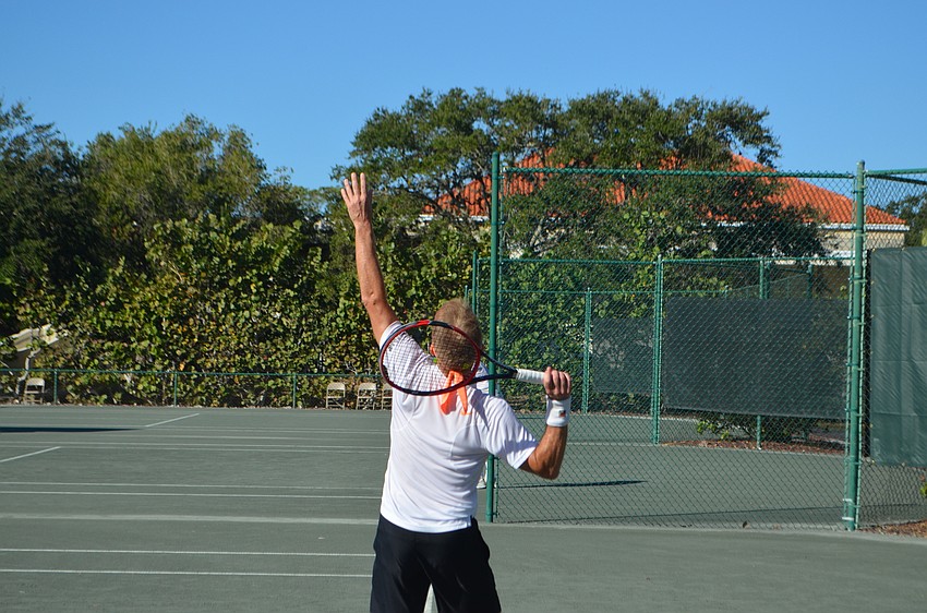 Eric Friedman serves the ball during the men’s 55 doubles finals.