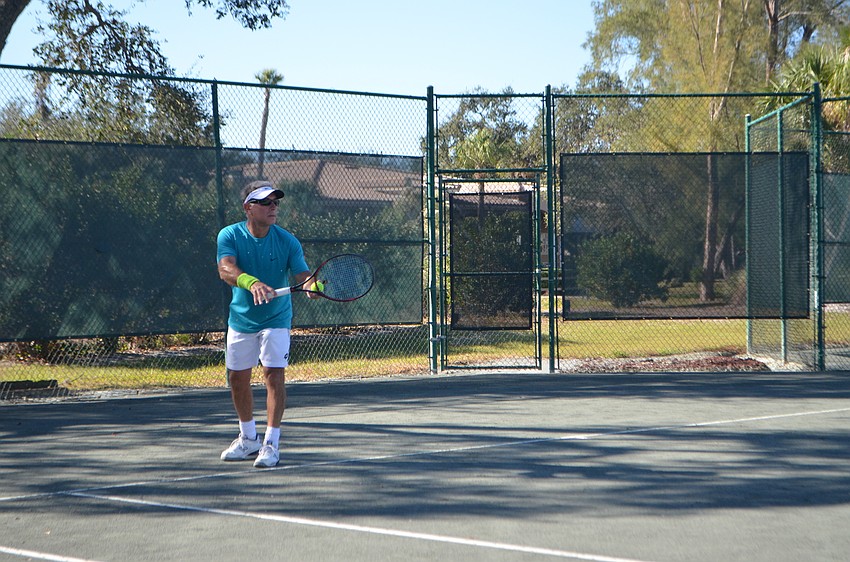 Tim Pier serves the ball during the men'      s 55 doubles final match.