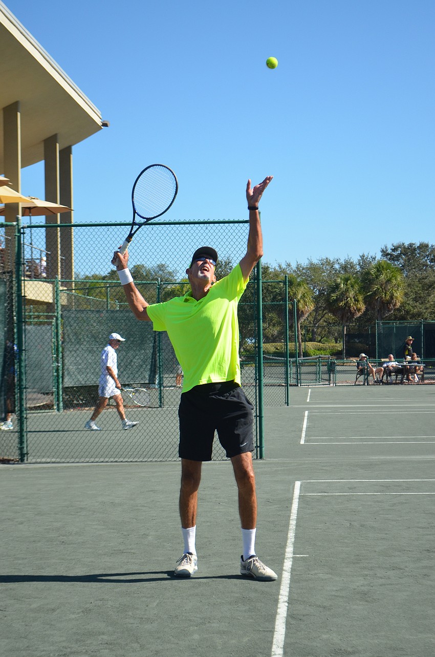 Larry Turville serves during the men’s 65 singles finals.