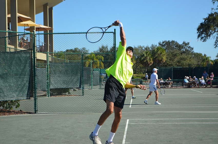 Larry Turville takes a swing during the men’s 65 singles final match.
