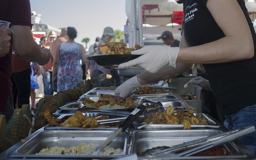 Jordan Brooks serves Siesta Beach Seafood and Music festival attendees.