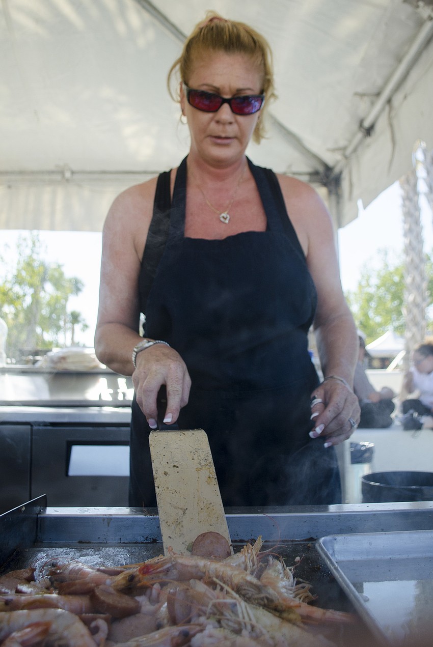 Ilisha Poole prepares Key West  pink prawns during the Siesta Beach Seafood and Music Festival.
